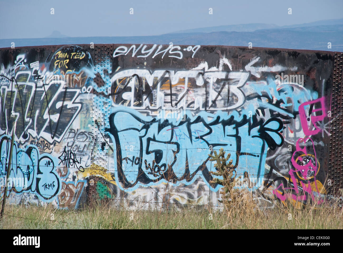 This water tank along the Turquoise Trail that connects Albuquerque to Santa Fe, is a graffiti creator's delight. Stock Photo
