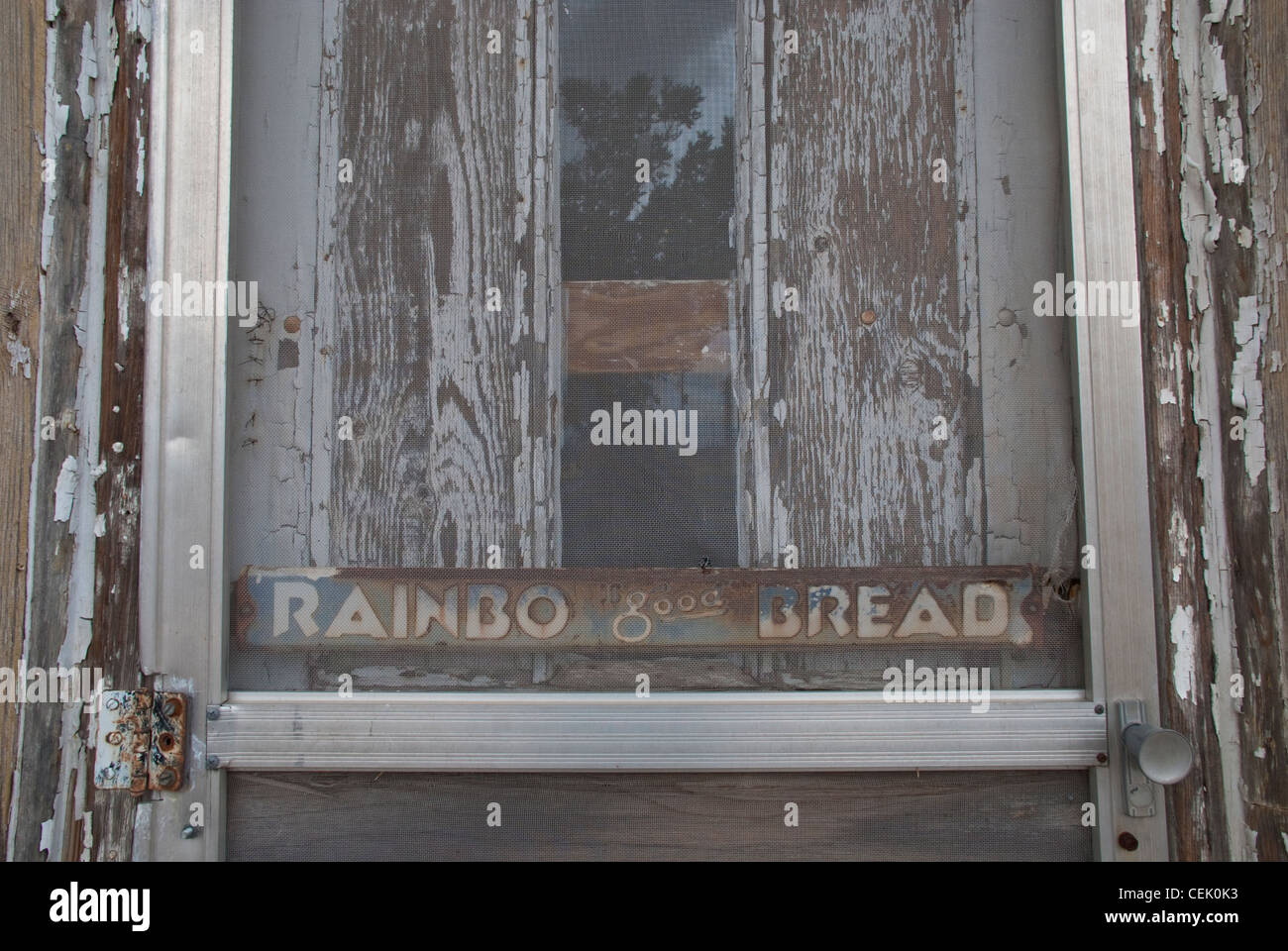 'Rainbo good Bread can still be seen on the entrance door to an old grocery store in Fort Sumner, New Mexico. Stock Photo