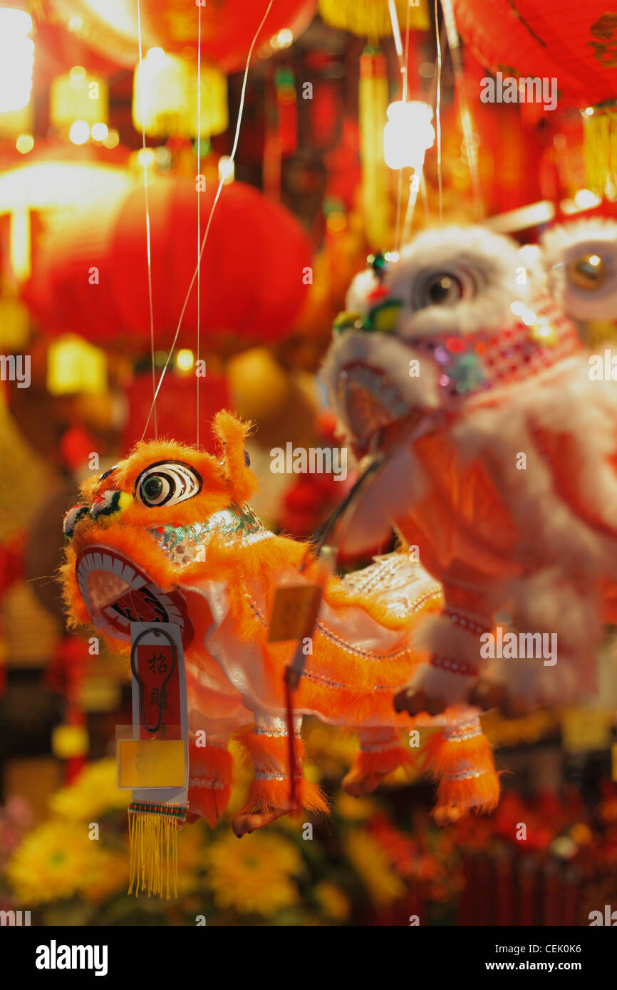 Close up of toy dragons hanging in market. Stock Photo
