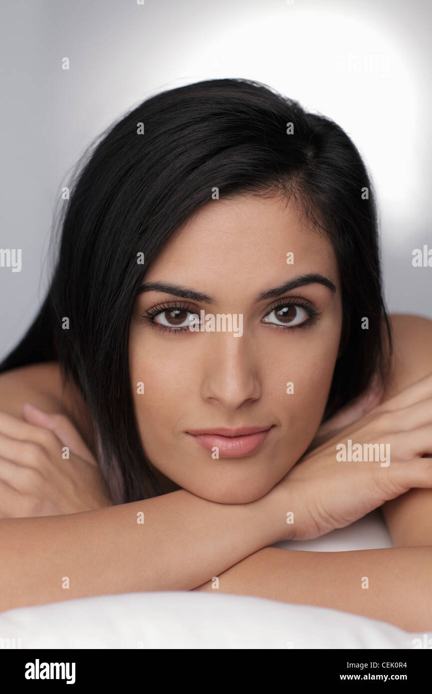 Head shot of young woman resting her chin on her arms Stock Photo Alamy