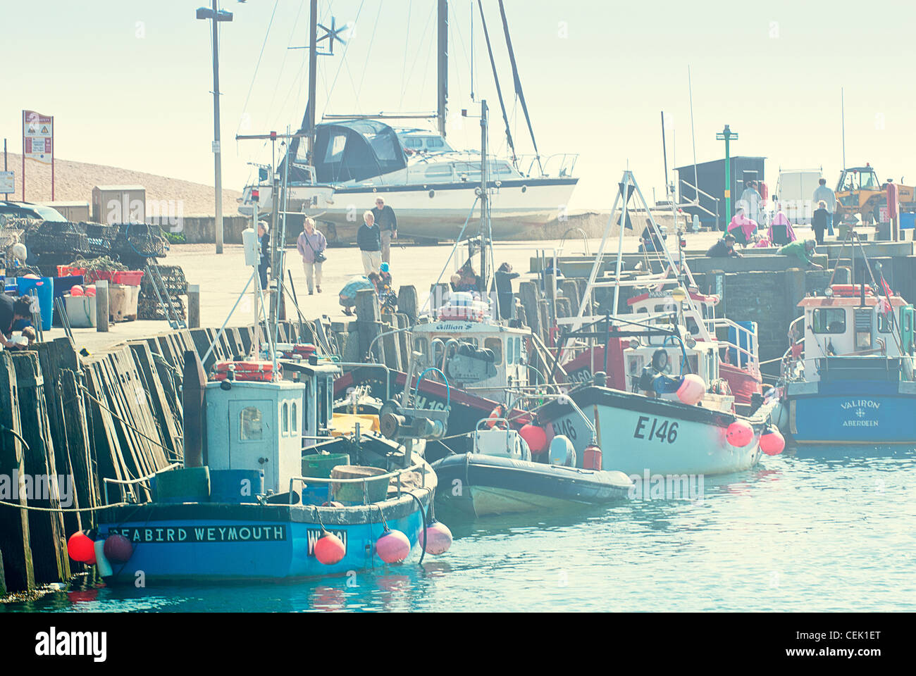 cute fishing boats in harbour, west bay, dorset england Stock Photo - Alamy