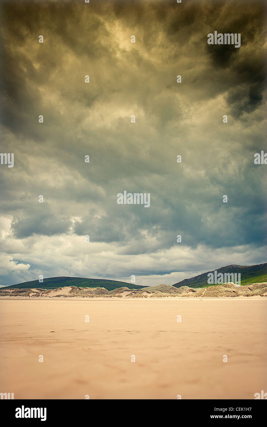 moody skies over deserted yellow sandy beach, gower wales Stock Photo