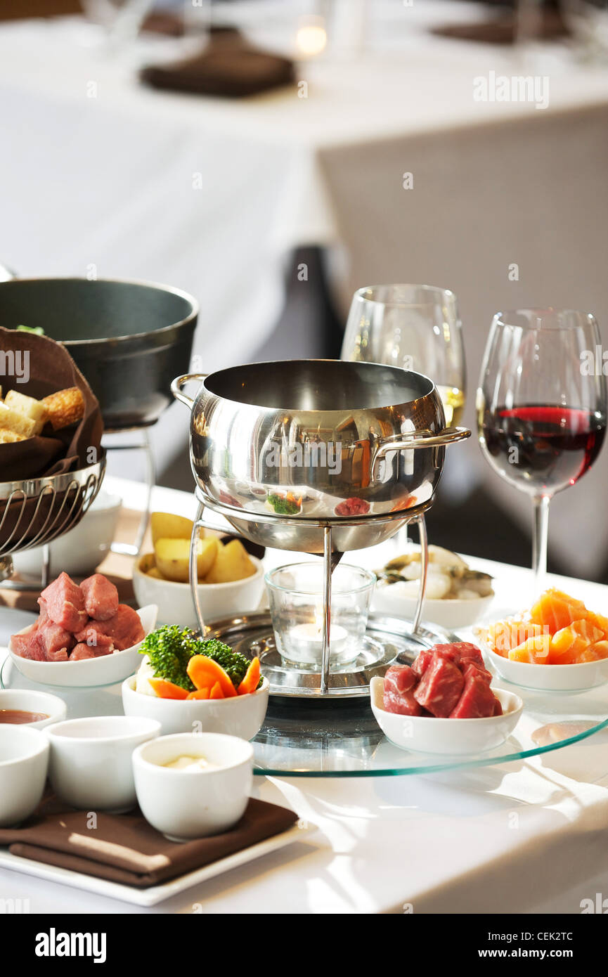 Fondue plate at a restaurant. Cheese, traditional oil, and chocolate