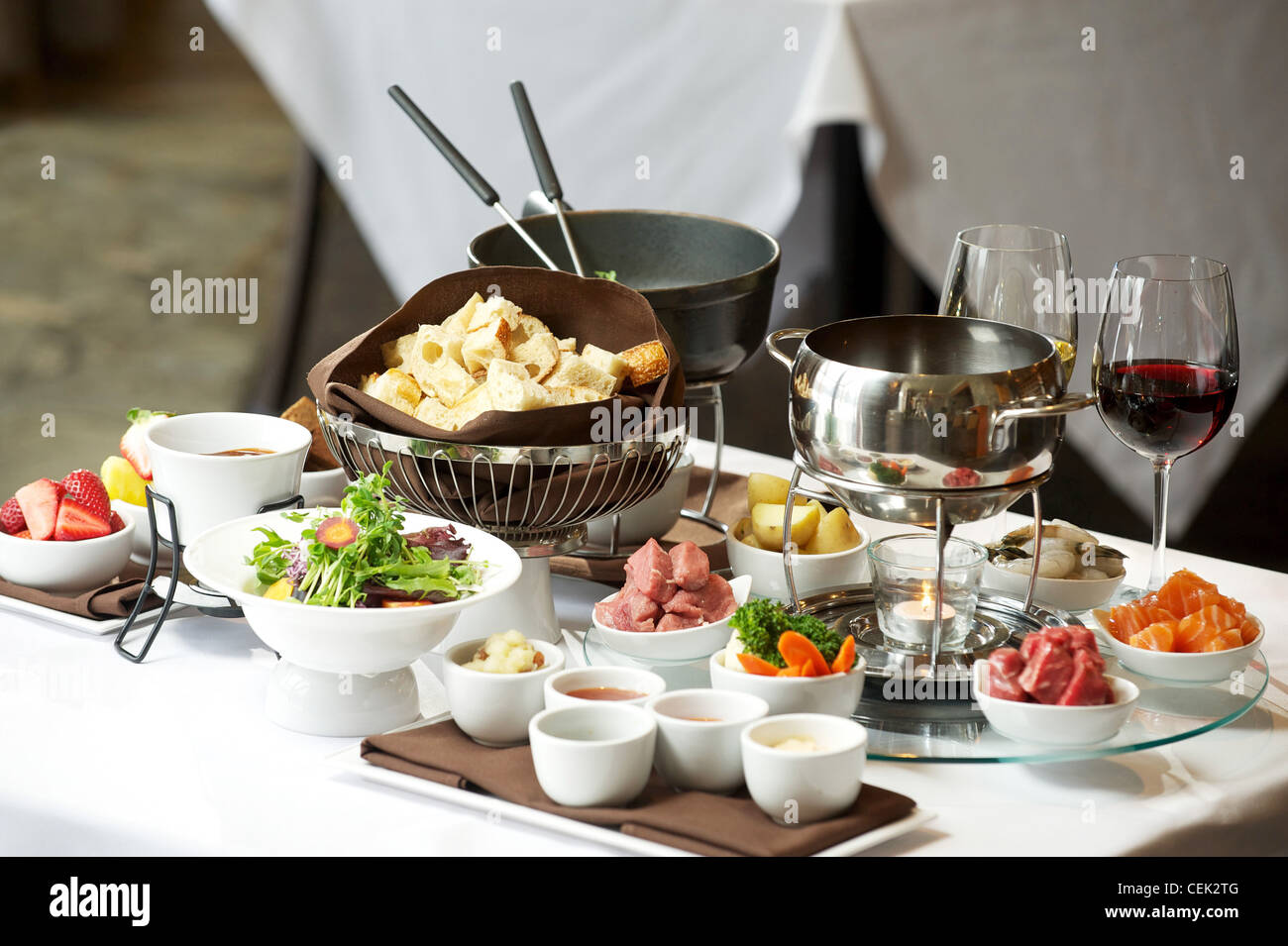 Fondue plate at a restaurant. Cheese, traditional oil, and chocolate
