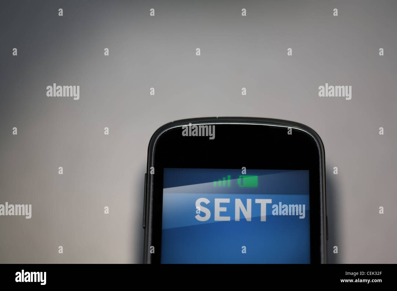 A mobile phone with sent message on the screen Stock Photo