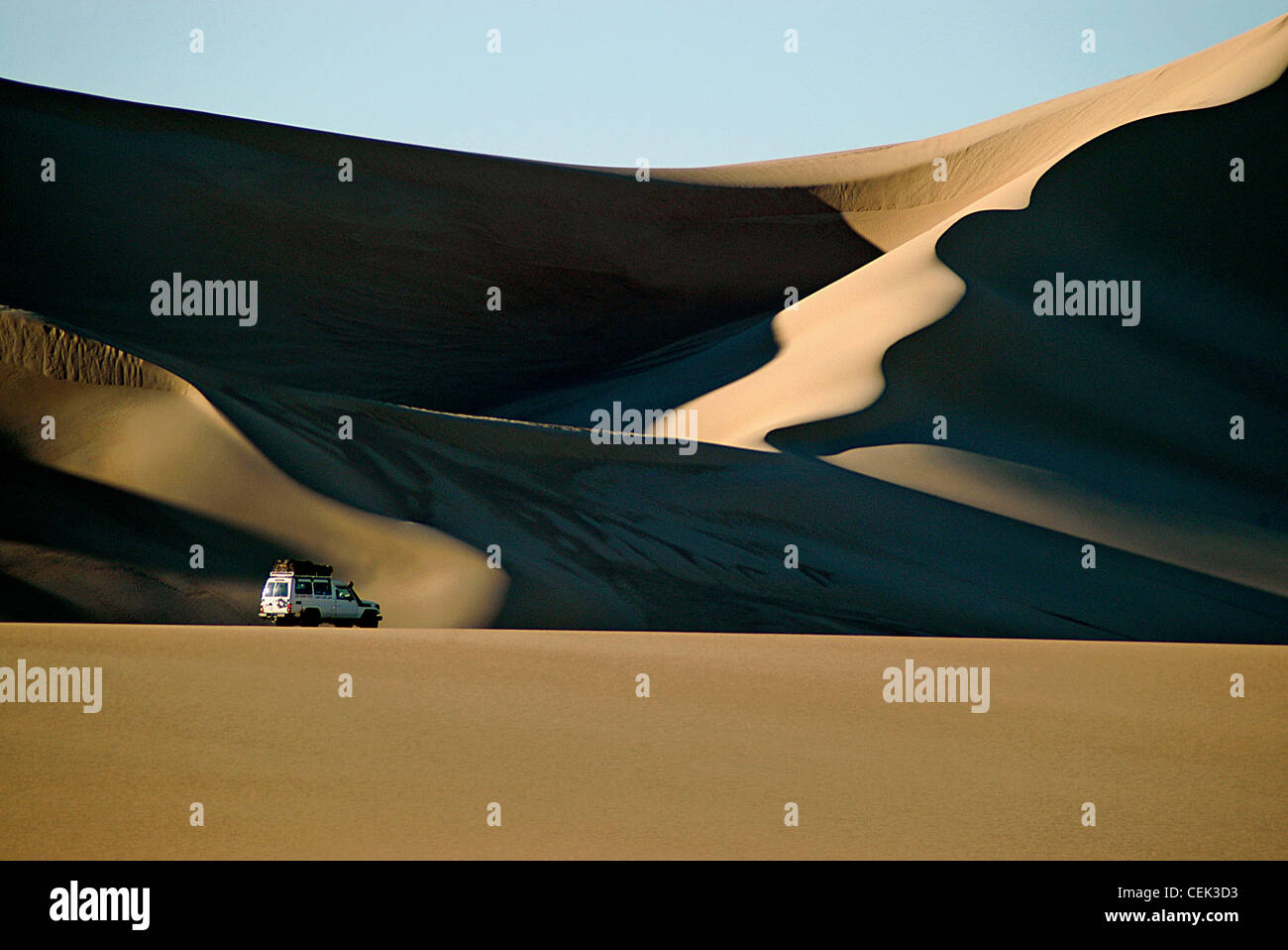 Vehicle crossing massive Sand dunes in Egypt's Western desert in the