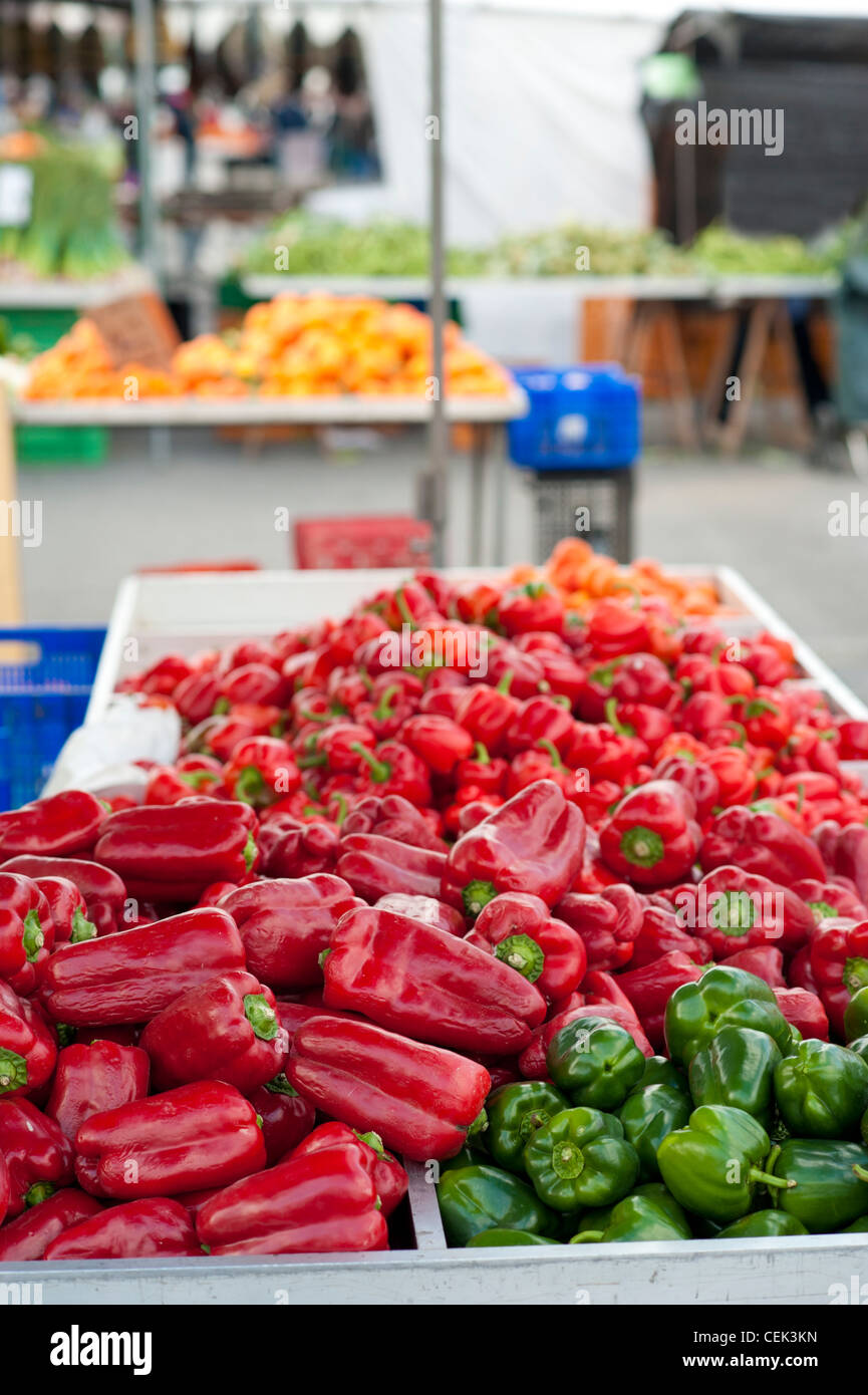 Red and green peppers on display at a street market stall Stock Photo ...