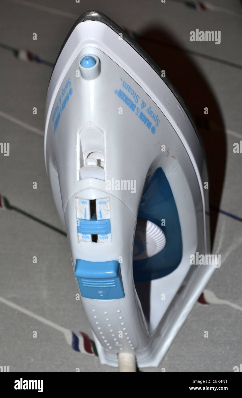 Iron on ironing board Stock Photo Alamy