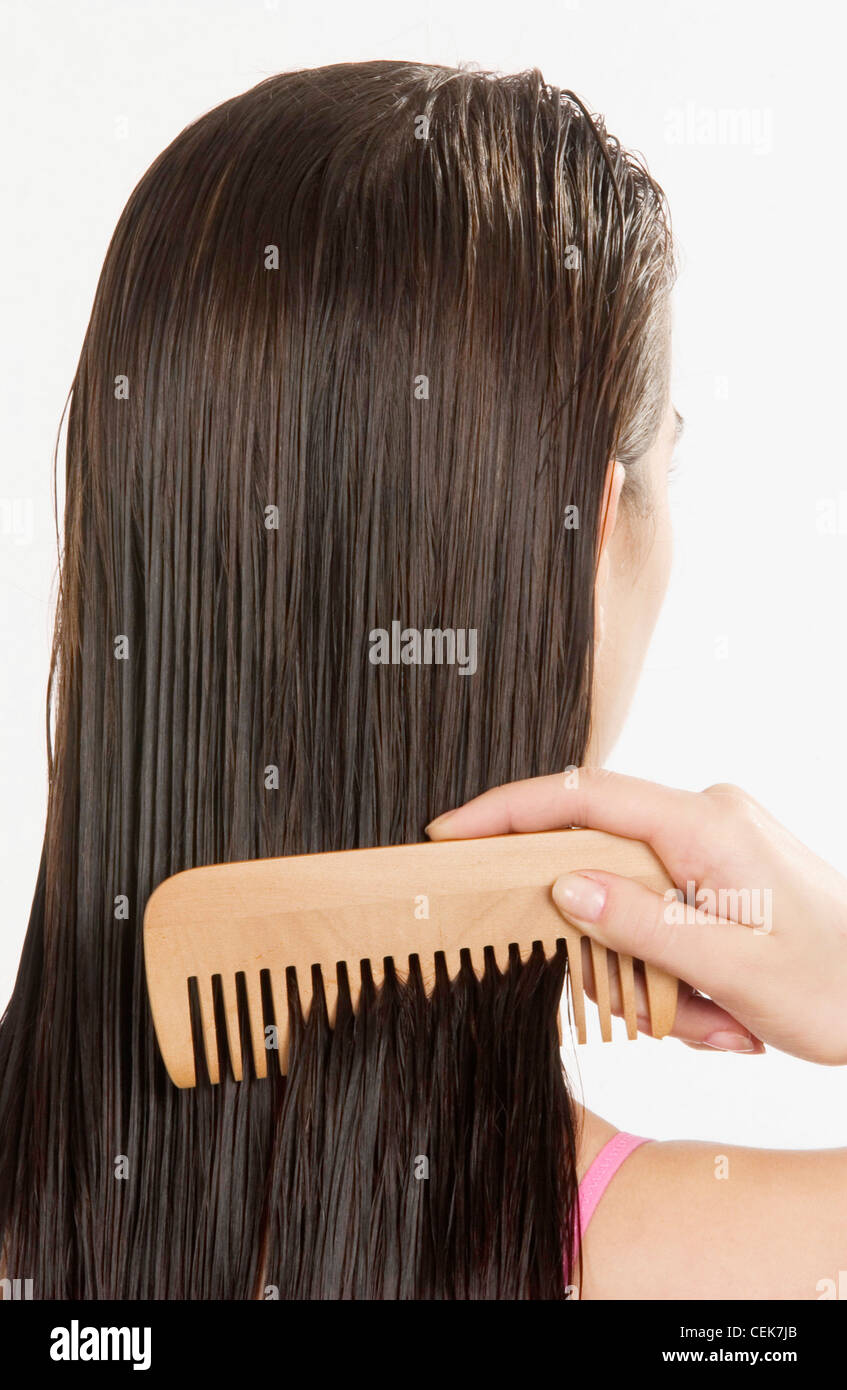 Back View Of Female With Long Wet Straight Brunette Hair Using