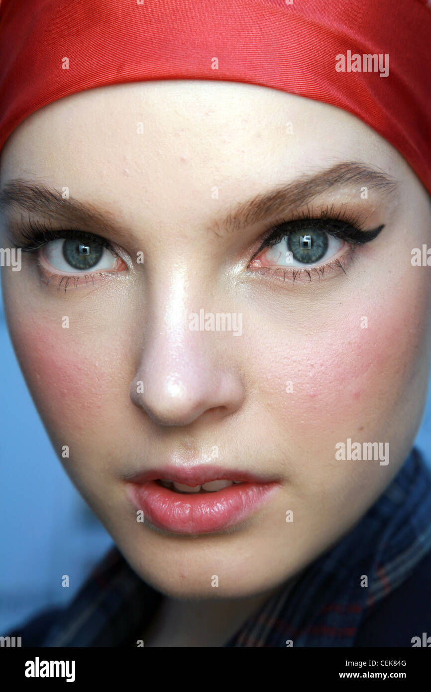 Aquascutum Backstage London Ready to Wear Autumn Winter Close up face of female wearing red headscarf, red blusher, subtle red Stock Photo