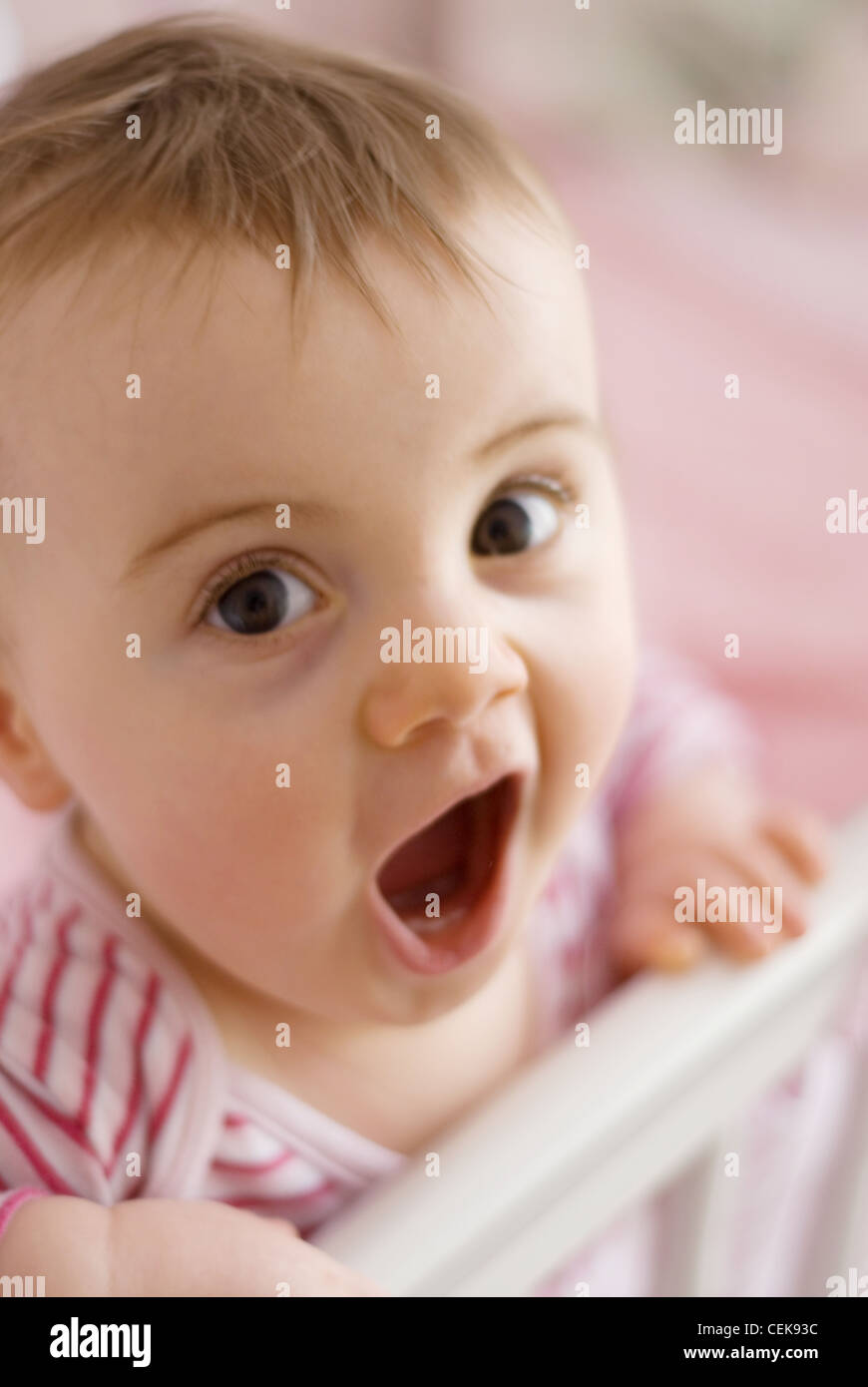 A Female Baby Fair Hair Wearing A Pink Striped Top Standing In