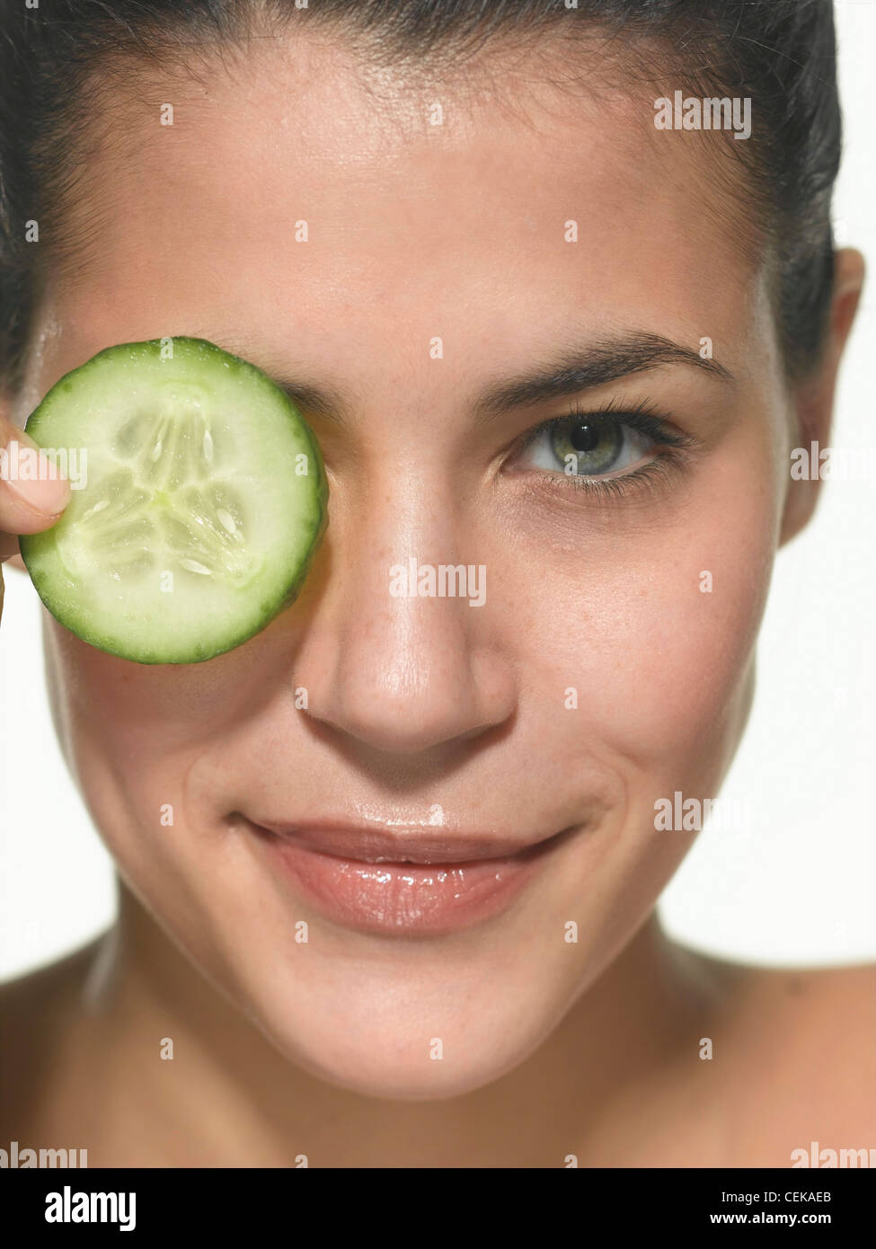 Woman holding cucumber over eye hires stock photography and images Alamy
