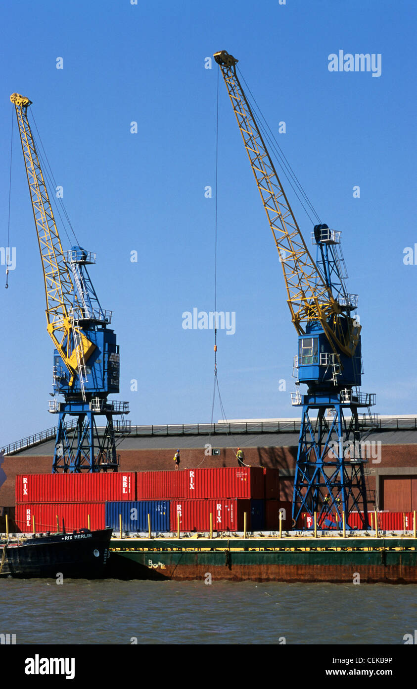 cranes unloading containers from container ship at the port of hull