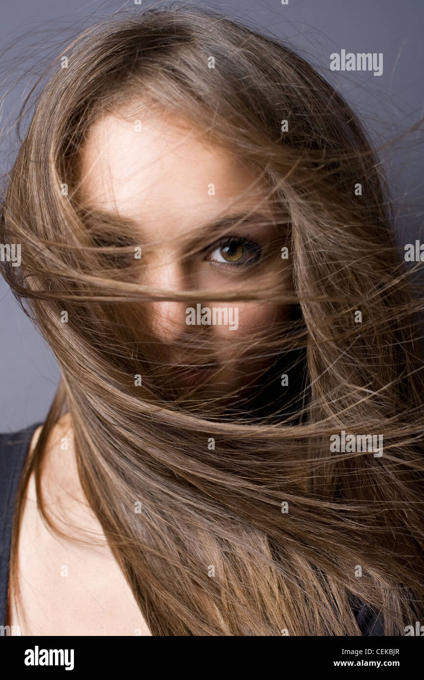 Eye contact, closeup artistic portrait of a beautiful young brunette