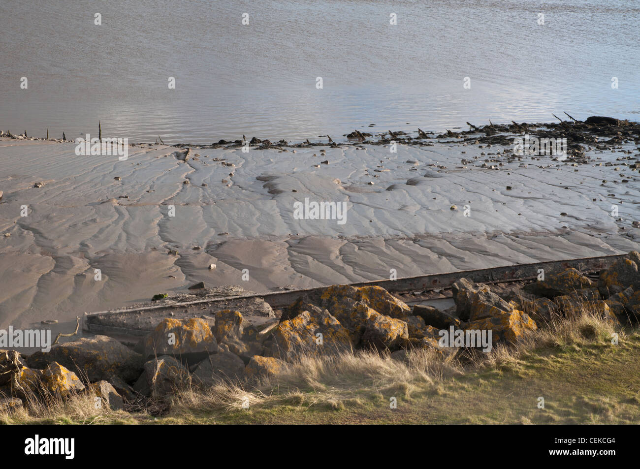 sand and mud banks with rocks at low tide Stock Photo