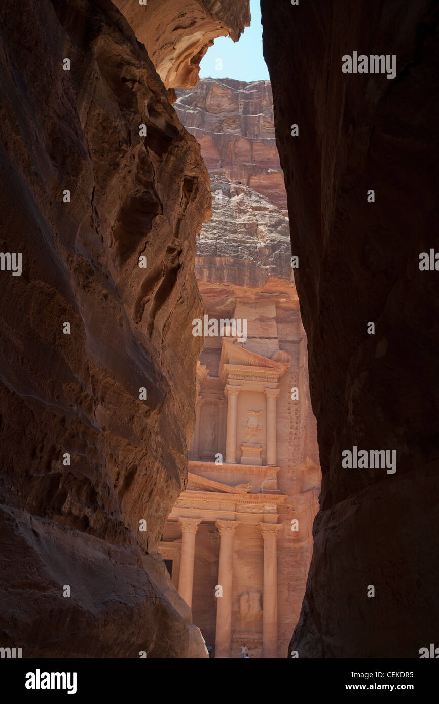 Siq narrow natural gorge leads into Nabataean city Petra opens in front Treasury building (el Khazneh) facade khazneh carved Stock Photo