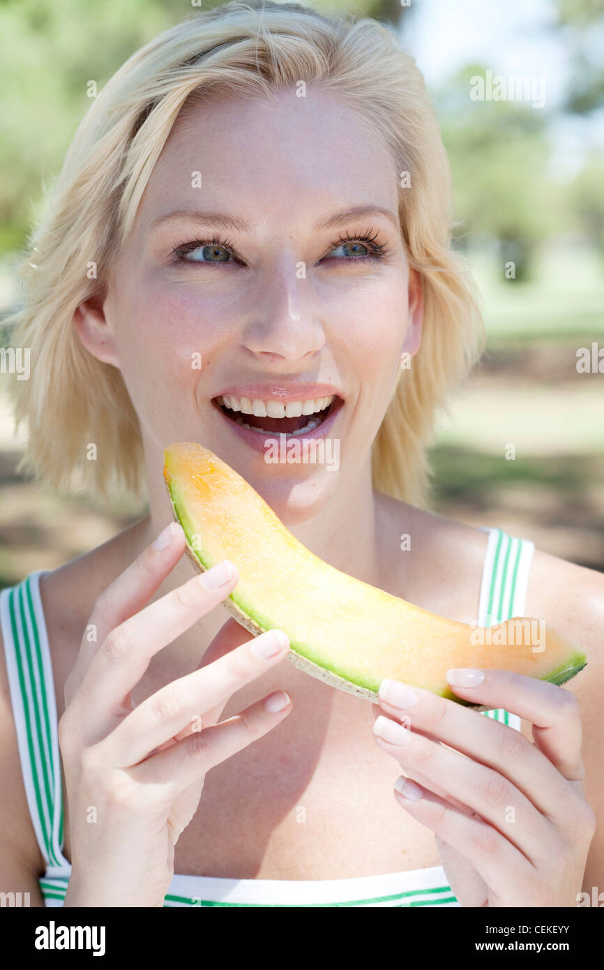 Female eating melon Stock Photo Alamy