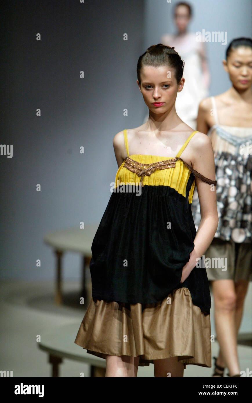 Pecoraro Milan Ready to Wear Spring Summer Three tone yellow brown black layered strappy sack dress jewelled chest and side Stock Photo