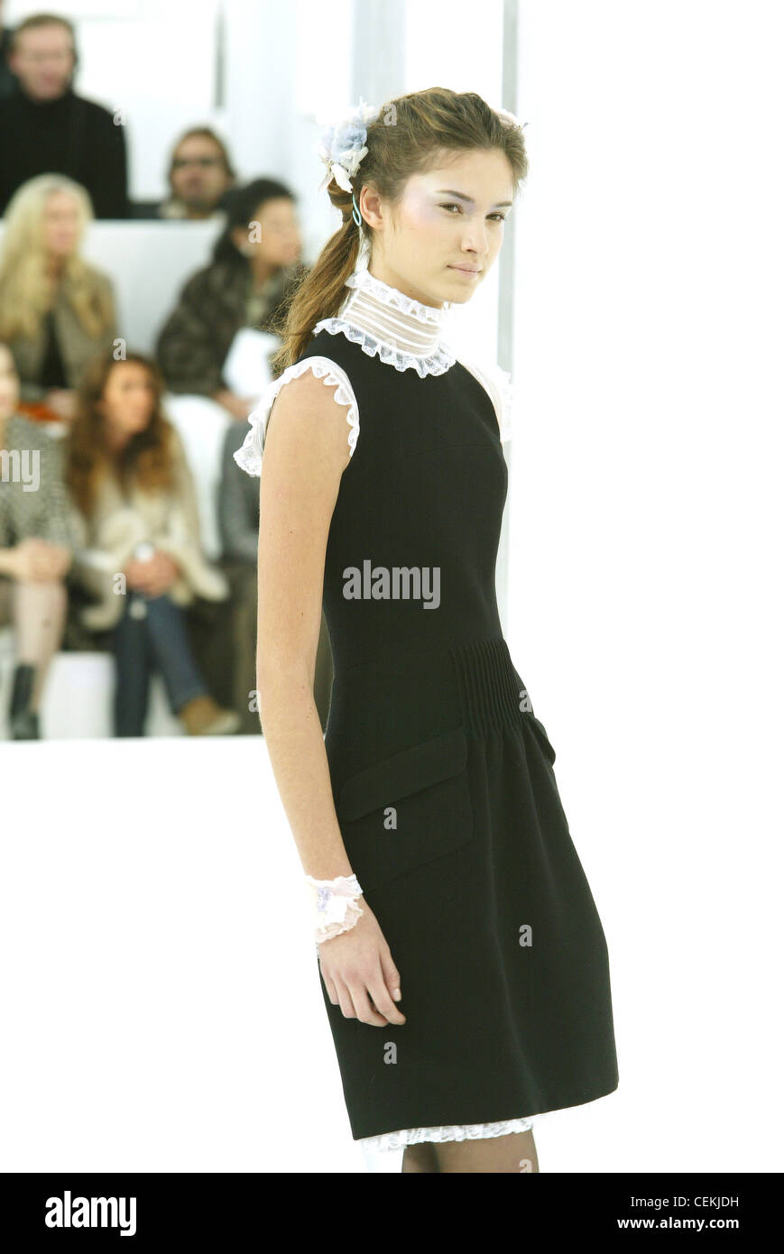 Haute Couture Chanel Spring Summer Paris Blonde female wearing a mid thigh  length black sleeveless dress white organdy ruffle Stock Photo - Alamy