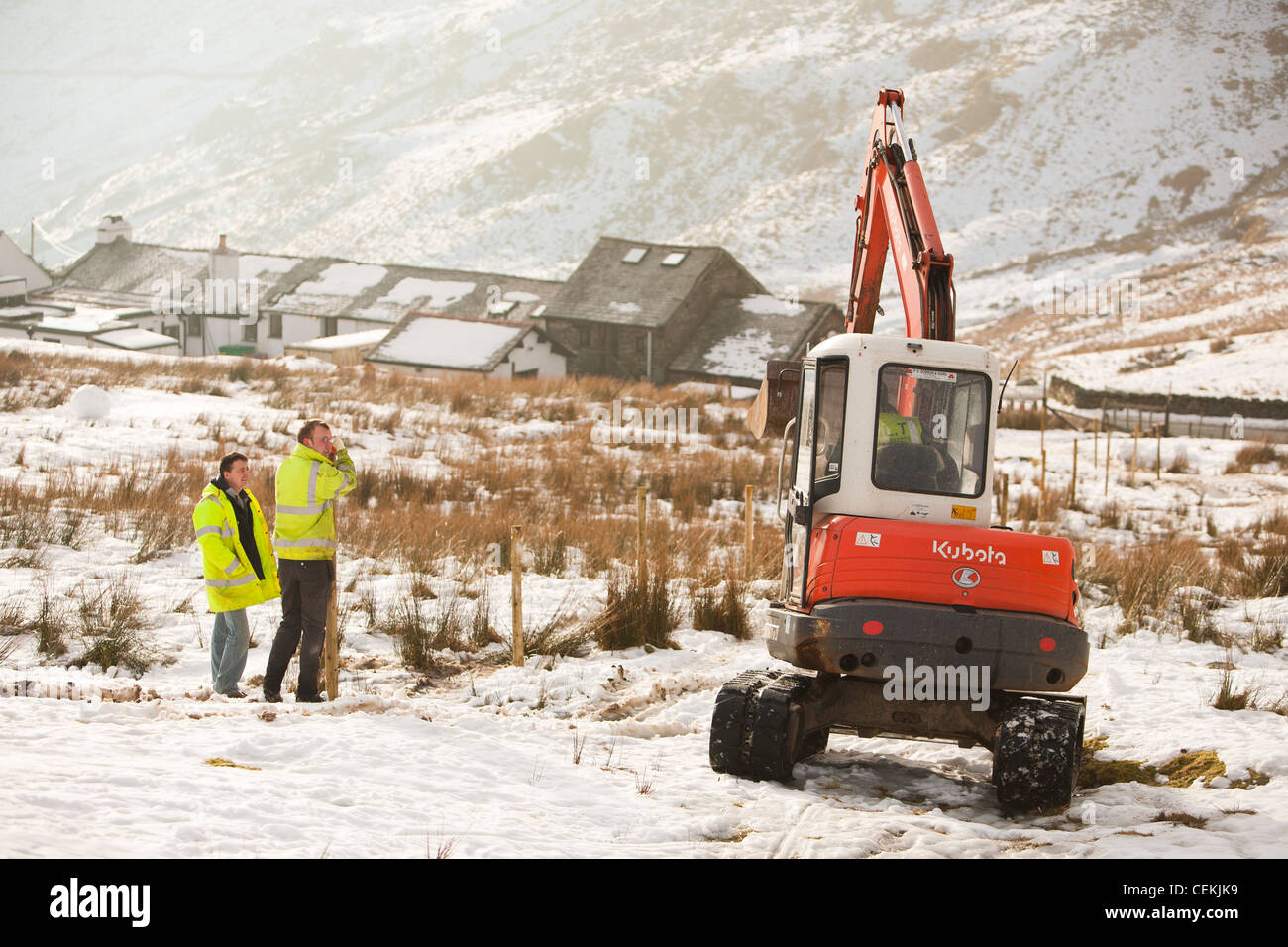 Workmen start the initial groundworks for 3 wind turbines to be constructed behind the kirkstone Pass Inn on kirkstone Pass Stock Photo