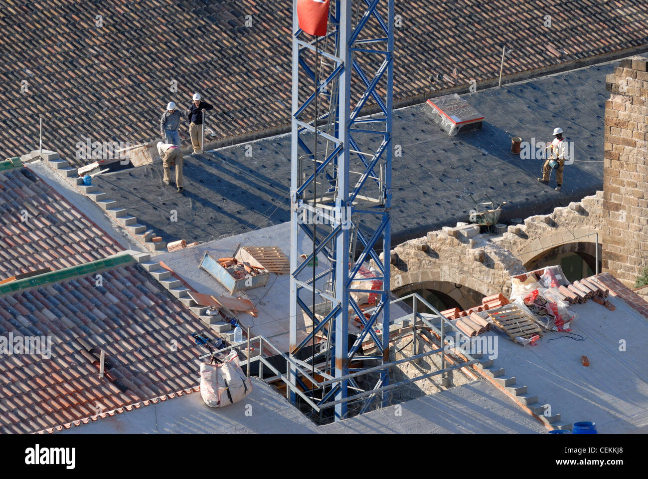 Barcelona, Spain. Men mending roof, seen from the top of the Monument a Colom / Monument to Columbus Stock Photo