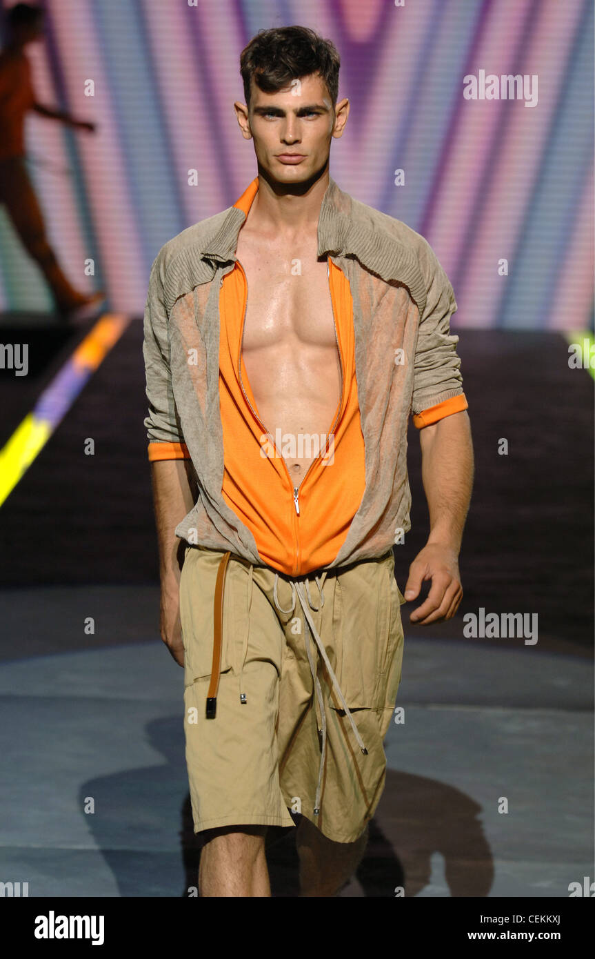 Versace Milan Ready to Wear Menswear Spring Summer Brunette male model  walking down the runway wearing chest revealing orange Stock Photo - Alamy
