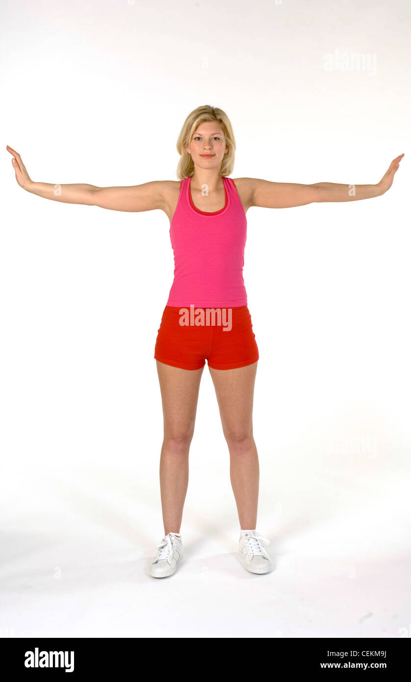 Female standing stretching arms out to side Stock Photo - Alamy