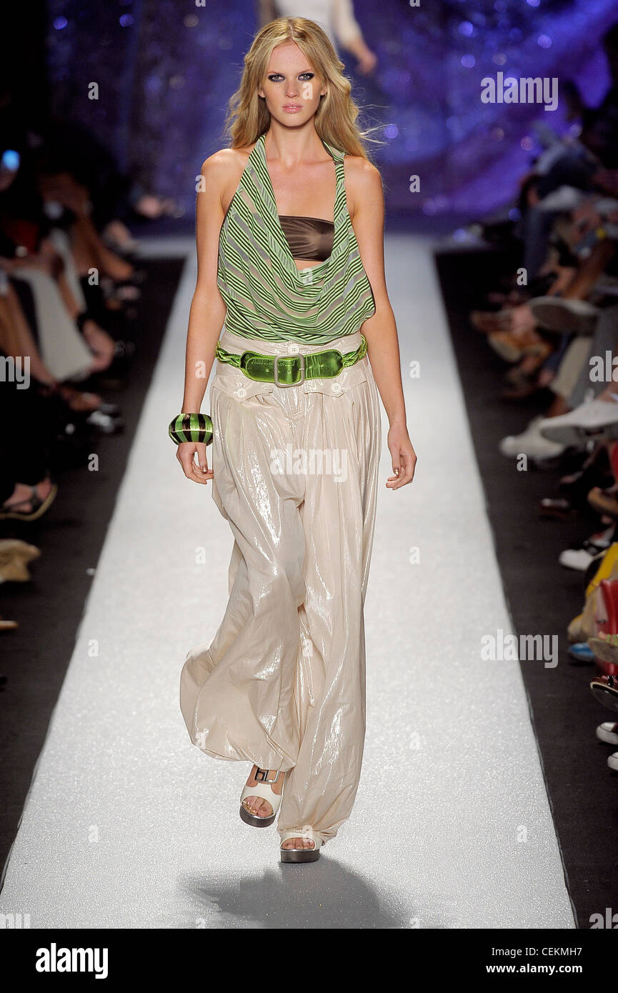 Miss Sixty New York Ready to Wear Spring Summer Model wearing a brown  bandeau bikini top, a green striped low cut sleeveless Stock Photo - Alamy
