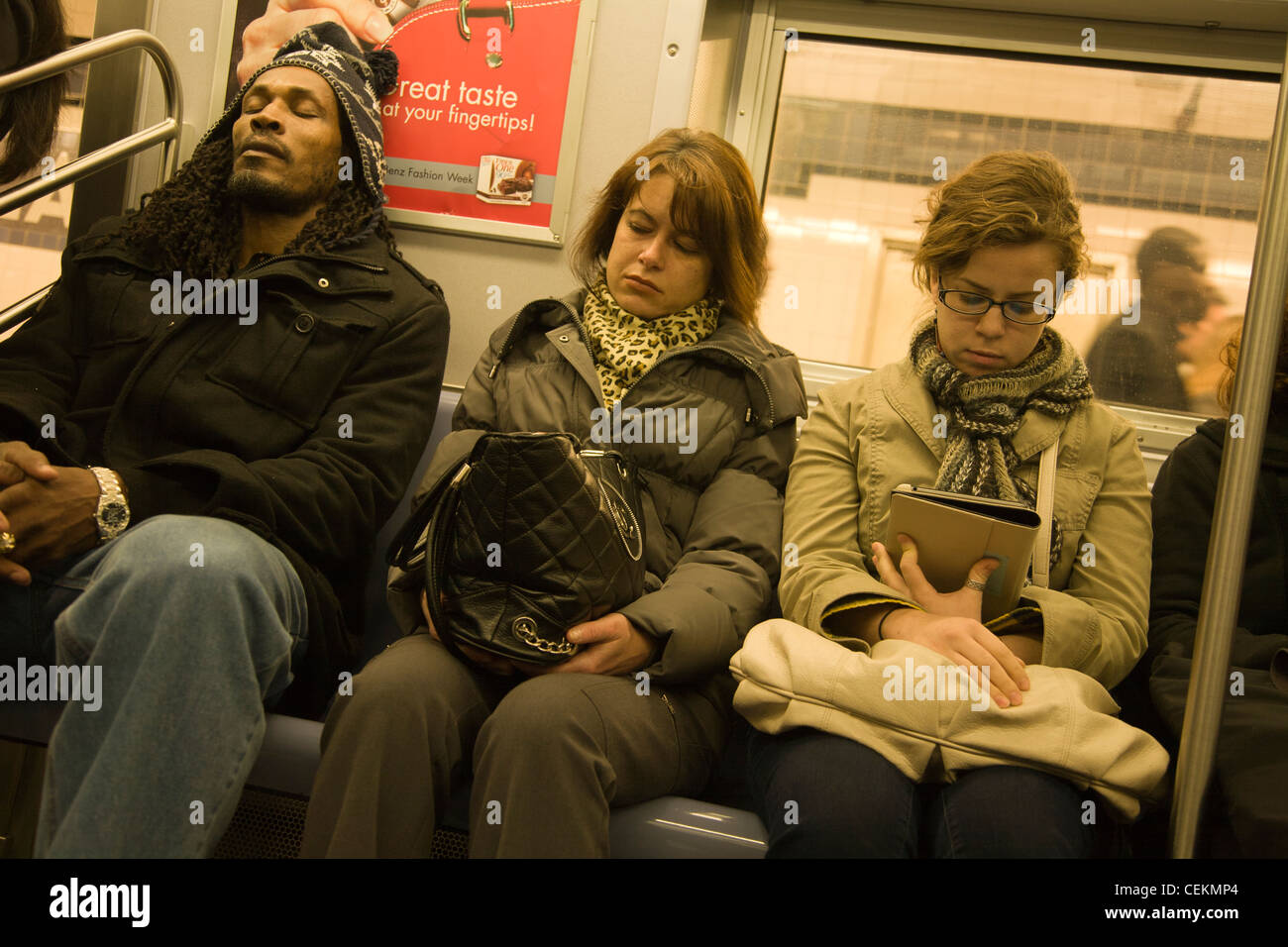 Riders on a subway train in New York City. Stock Photo