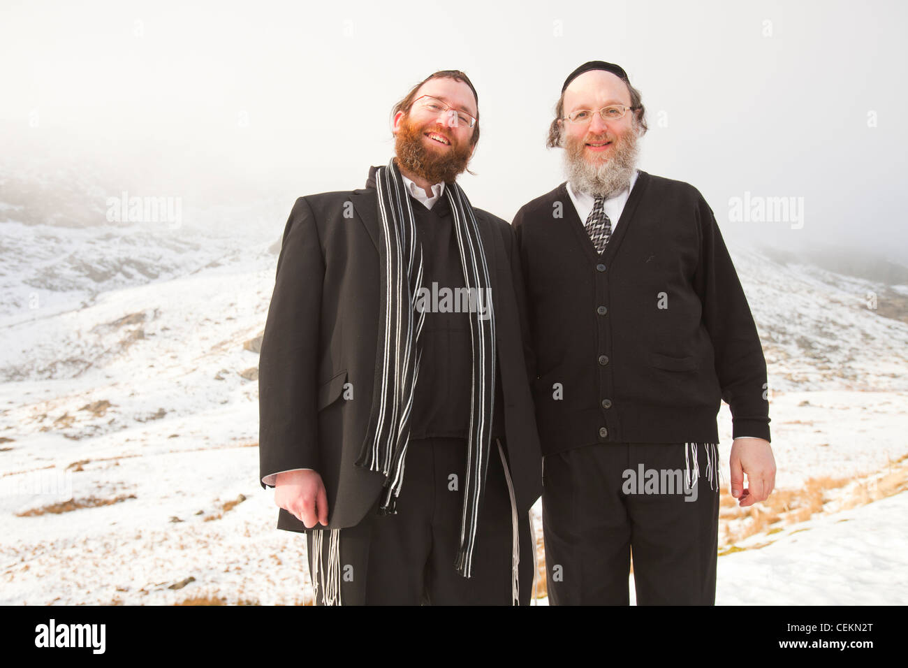 Two Jewish men on kirkstone Pass above Ambleside in the Lake District in snow. UK. Stock Photo