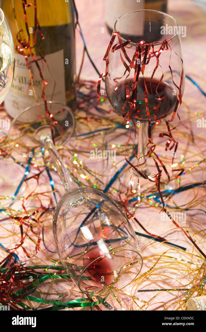 Glasses of red and white wine, streamers, tipped over glass, wine bottle Stock Photo