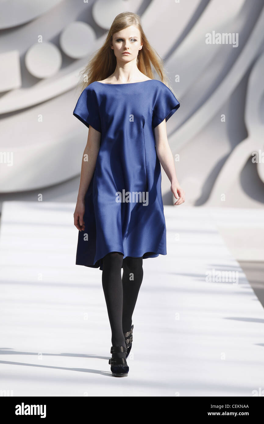 Alberta Ferretti Milan Ready to Wear Autumn Winter  Plain blue sack dress, black tights and strappy shoes Stock Photo
