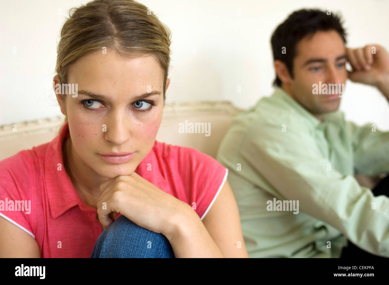 Couple sitting facing away from each other Stock Photo Alamy