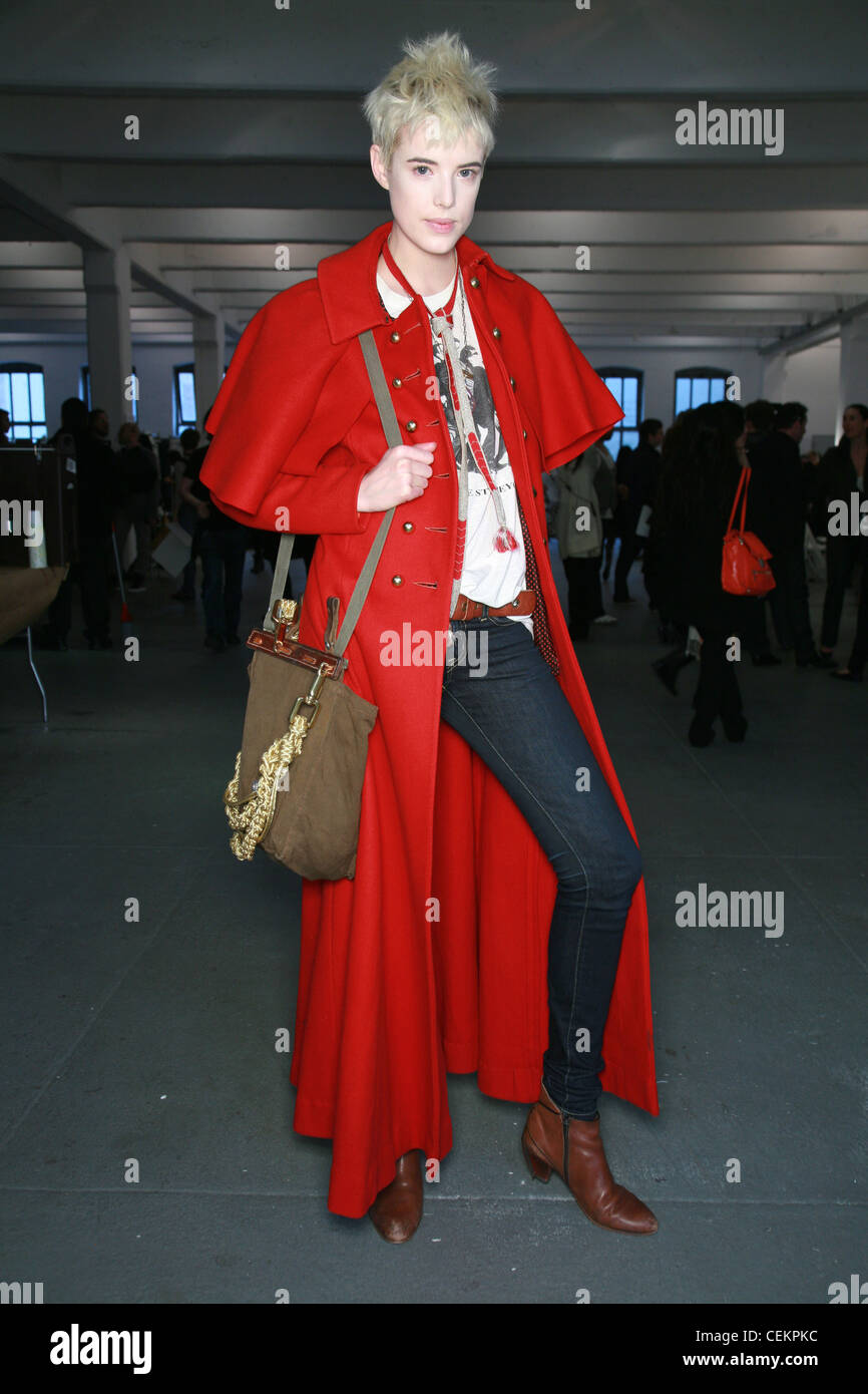 Rodarte BACKSTAGE New York Ready to Wear Autumn Winter Agyness Deyn wearing an ankle length red riding coat tight blue jeans Stock Photo