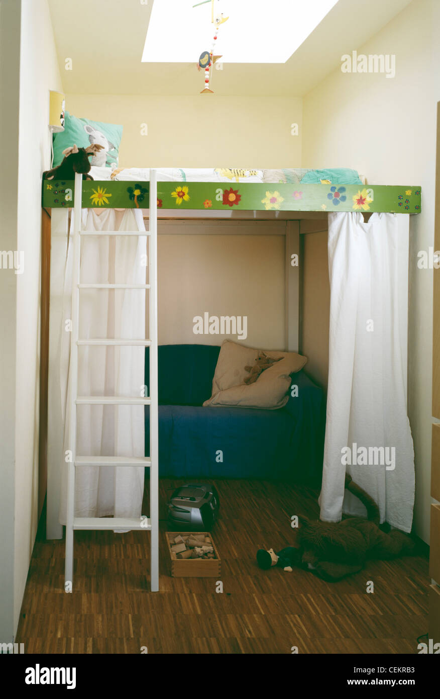 Bedroom With Raised Cabin Bed With White Ladder Over Blue Armchair