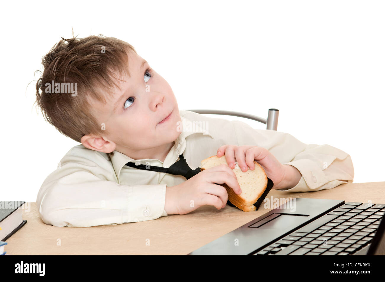 thoughtful boy eating a sandwich with his tie isolated on white background Stock Photo