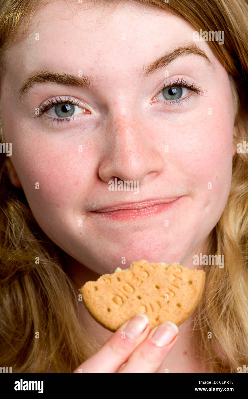 Female eating a digestive biscuit Stock Photo Alamy