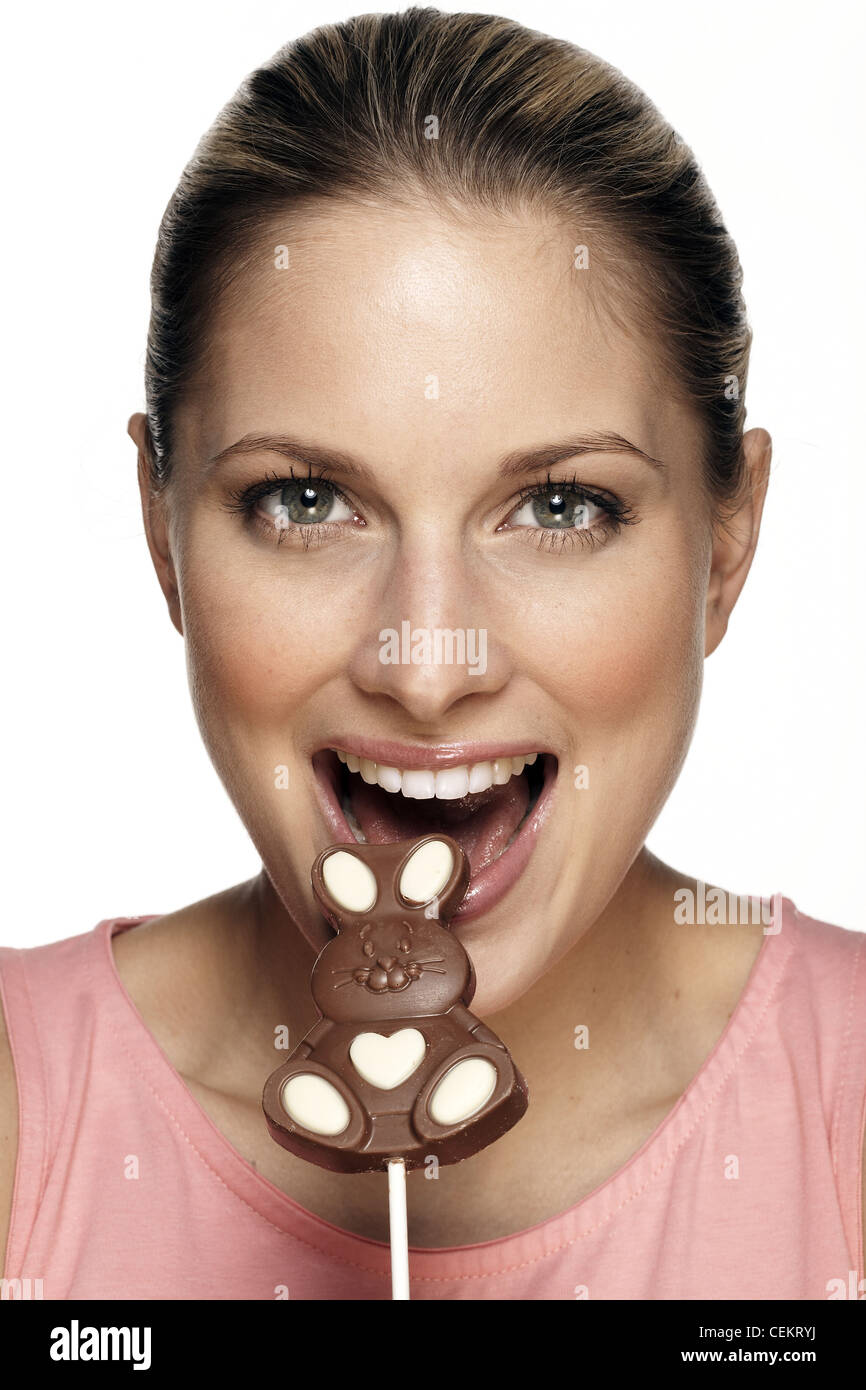 Female eating bunny shaped chocolate lolly Stock Photo Alamy