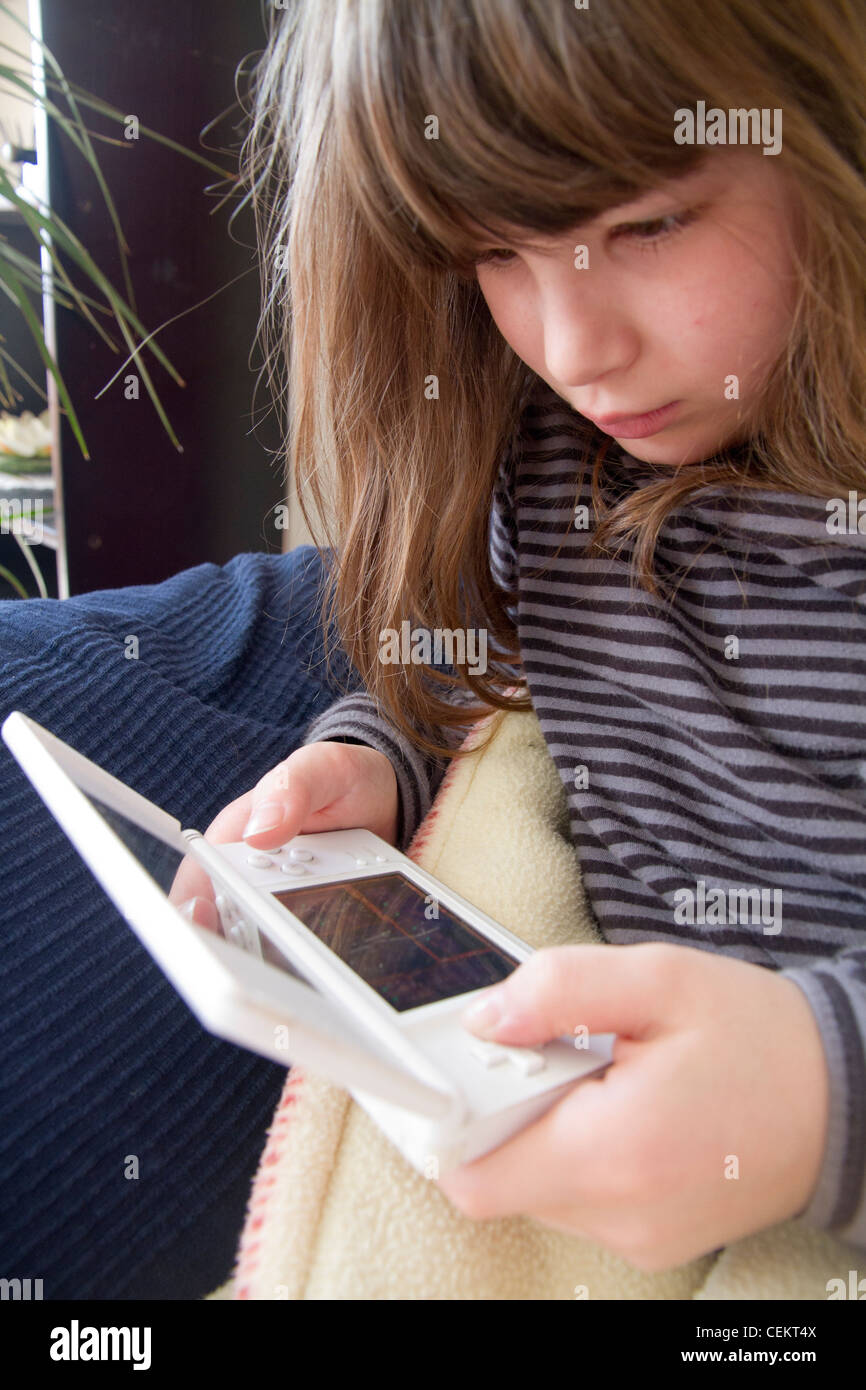 Young girl playing Nintendo ds game Stock Photo Alamy