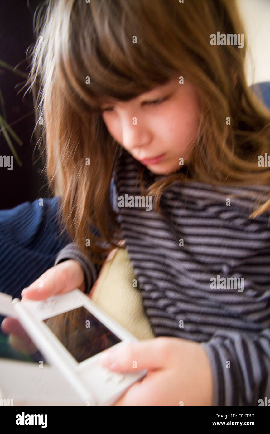 Young girl playing Nintendo ds game Stock Photo Alamy
