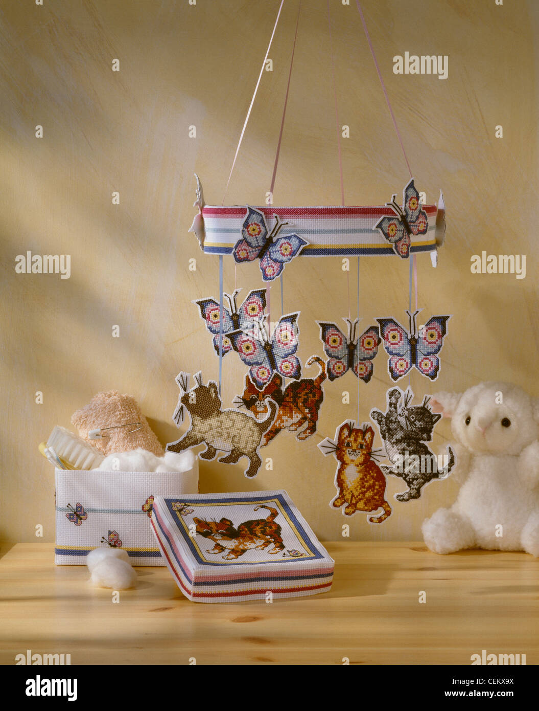 Nursery frolics A mobile kittens chasing butterflies and a bits and bobs box make novel nursery decorations The finished Stock Photo