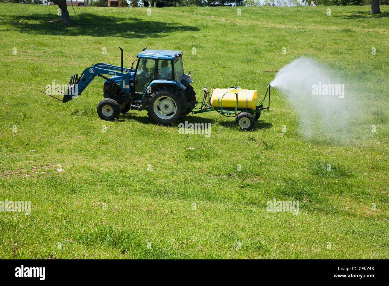 Spraying herbicide on a pasture used for grazing beef cattle. The