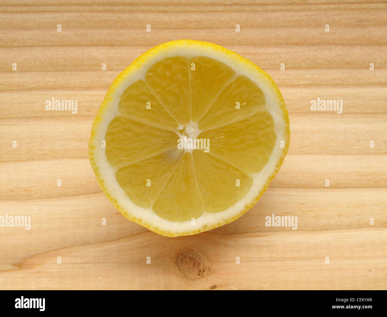 a half lemon on wood / halbe Zitrone auf Holz Stock Photo