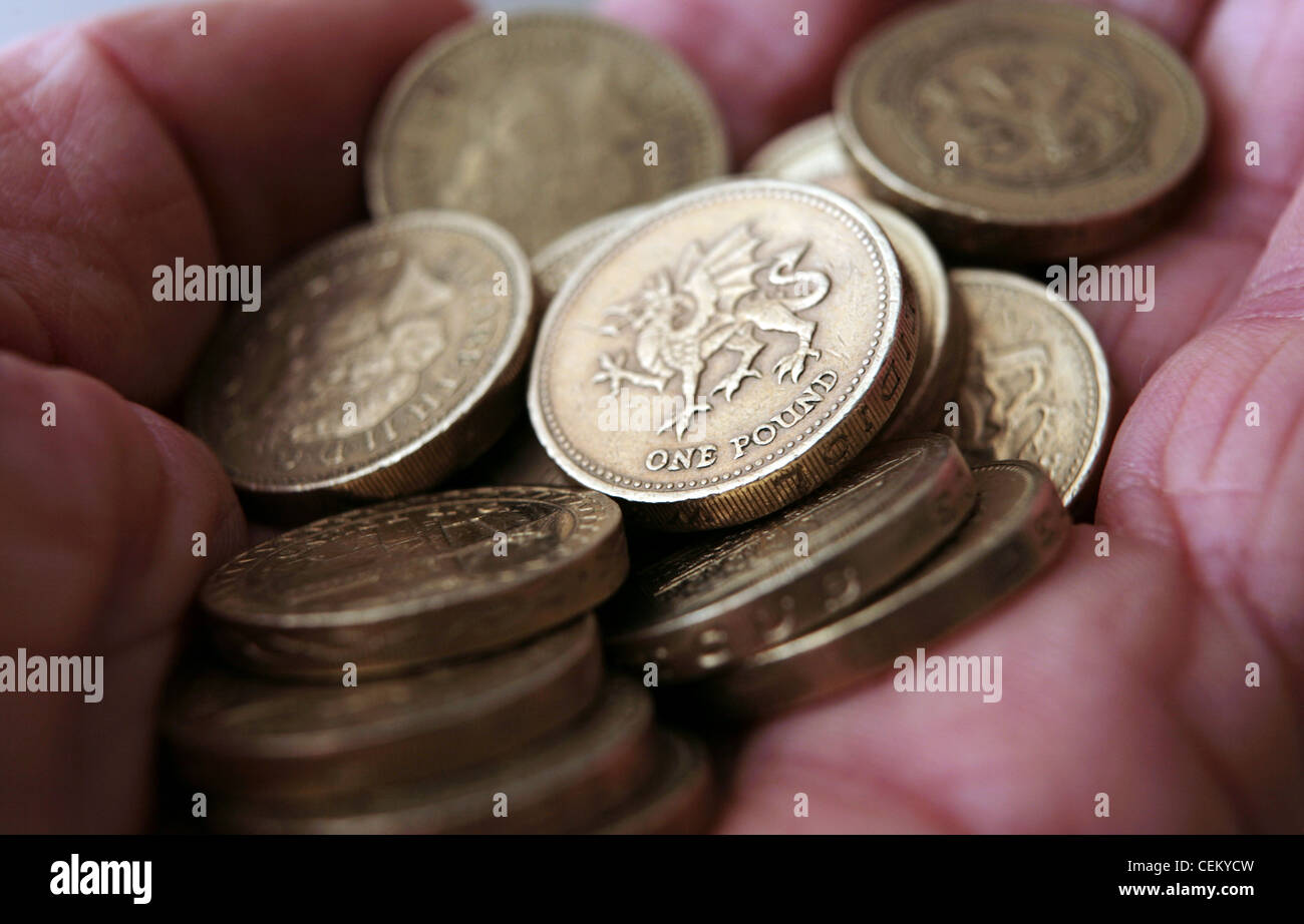 UK pound coins in the palm of a hand. Stock Photo