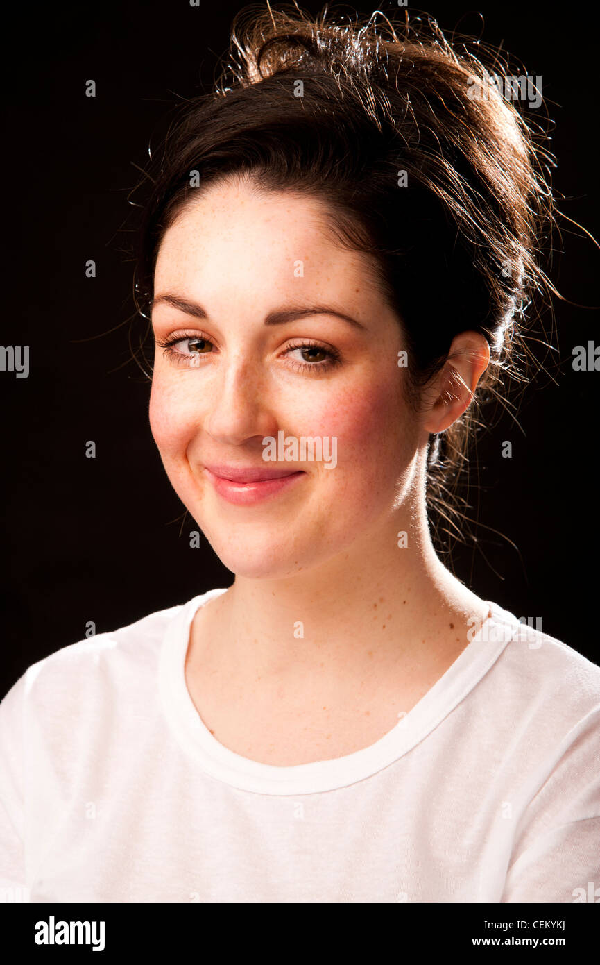 A 20 year old slim attractive healthy young adult woman girl with brown hair and eyes smiling Stock Photo