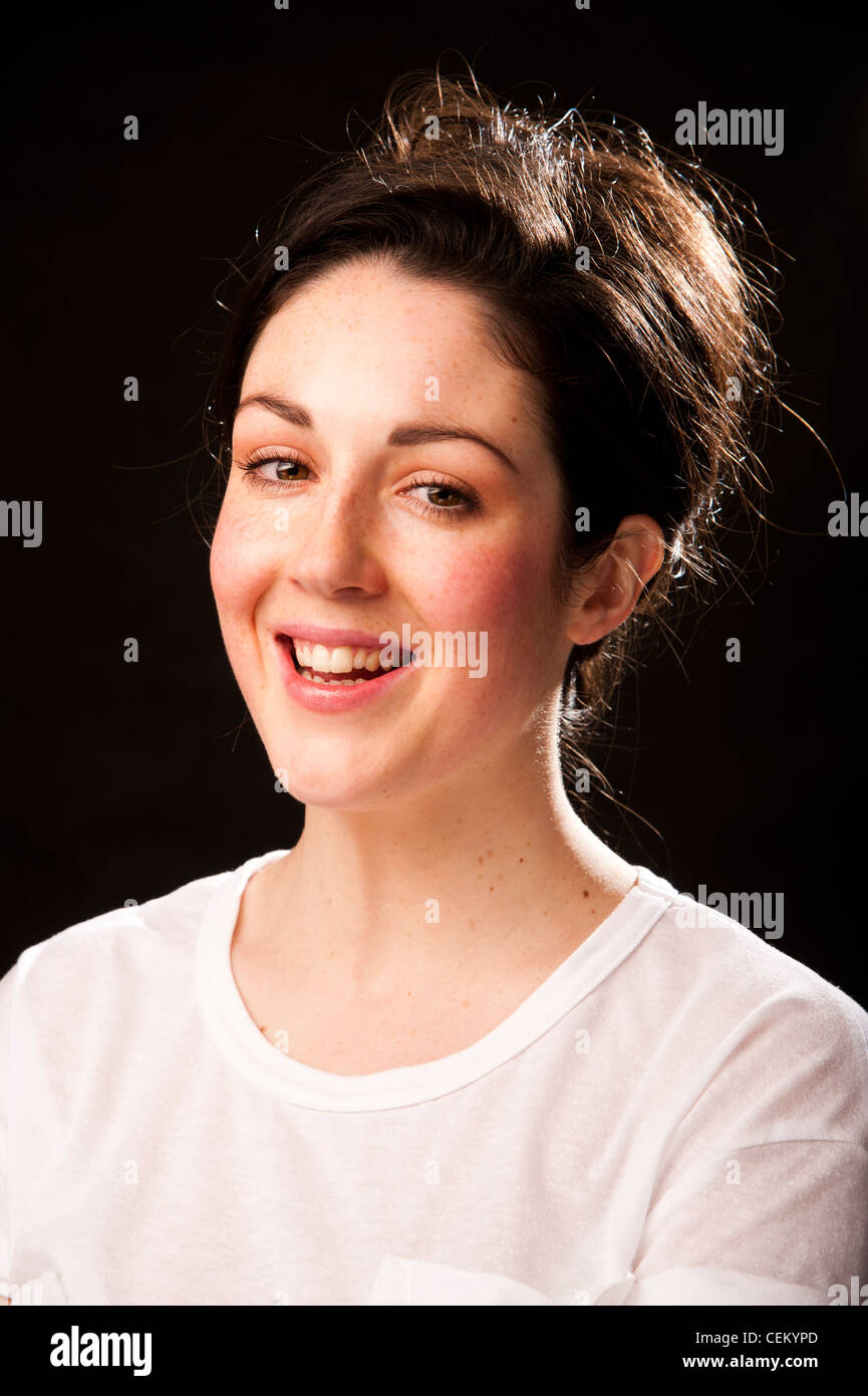 A 20 year old slim attractive healthy young adult woman girl with brown hair and eyes smiling Stock Photo