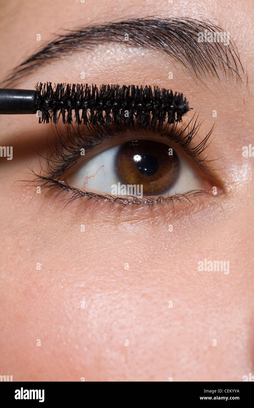 Female applying black mascara Stock Photo Alamy