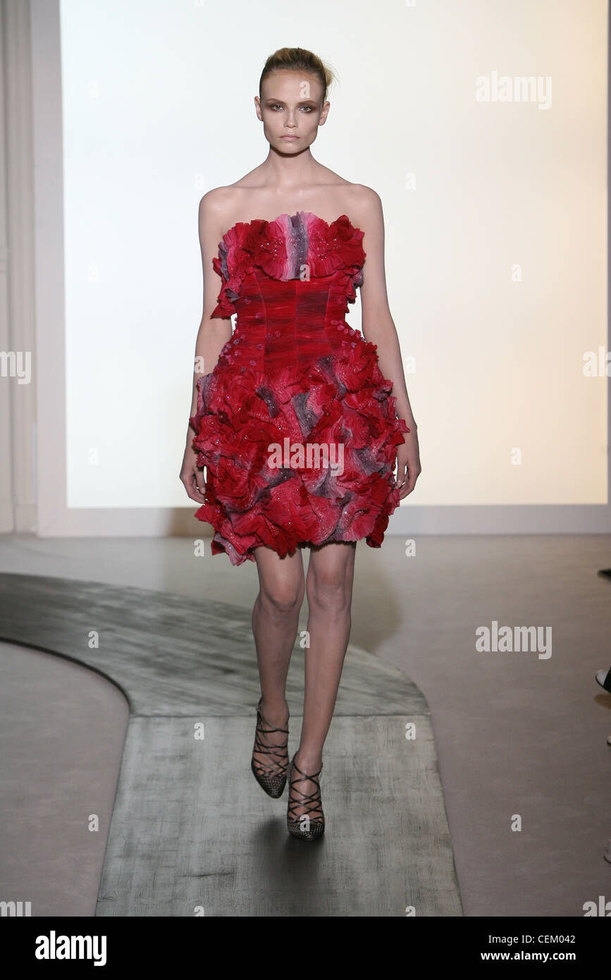 Valentino Paris Haute Autumn Winter Model wearing and pink sleeveless dress a fitted bodice and a ruffled skirt Stock Photo - Alamy