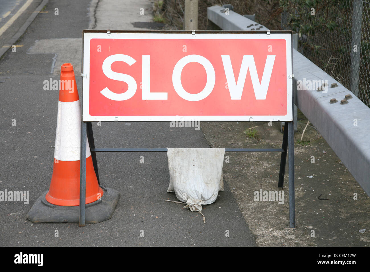 slow sign warning of roadworks ahead Stock Photo