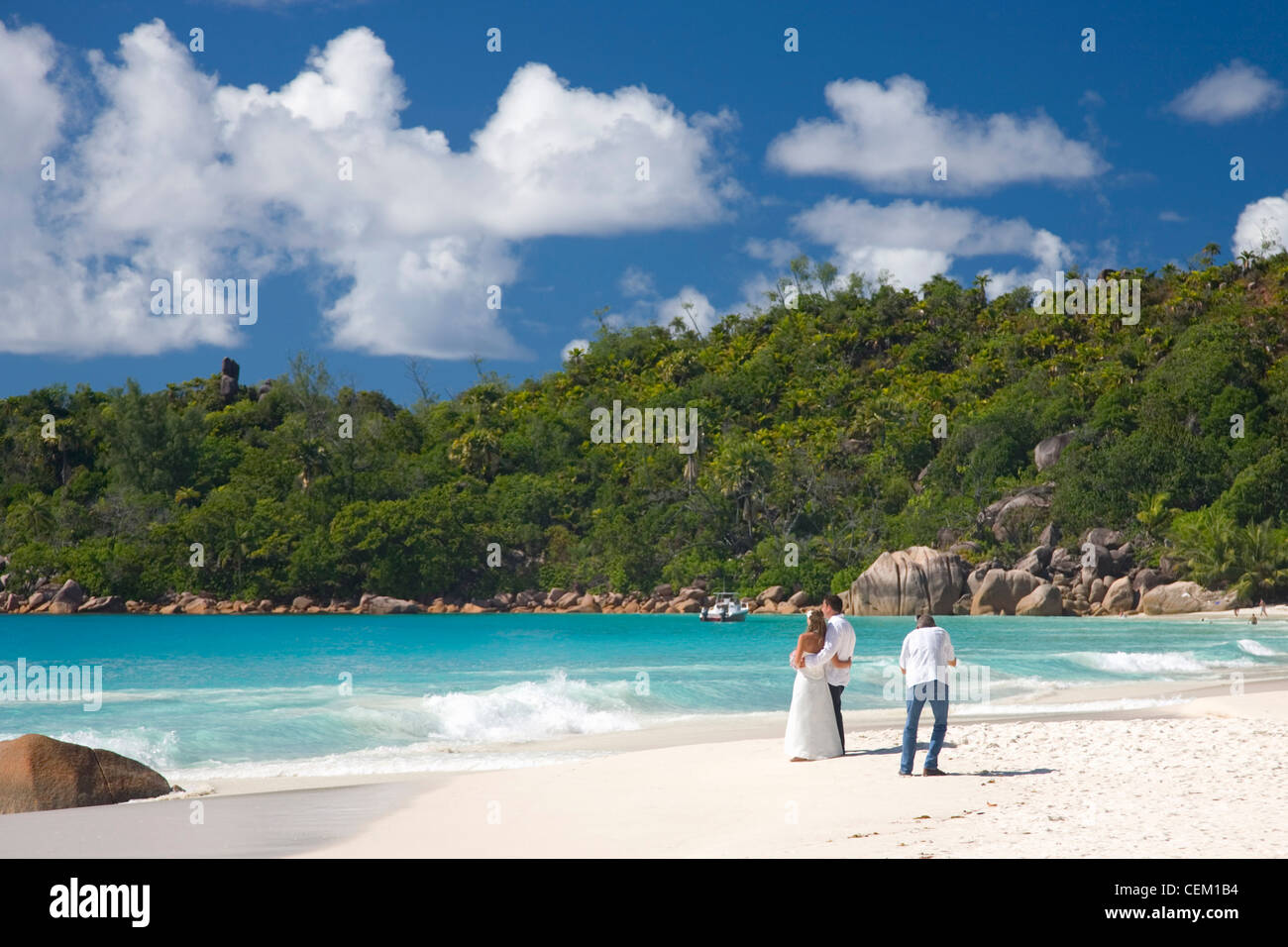 Anse Lazio, Praslin, Seychelles. Newly-weds being photographed on the beach. Stock Photo